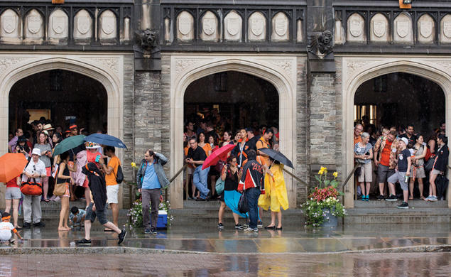 Reuners standing under the portico at Firestone Lirary to escape the rain during the 2018 P-rade