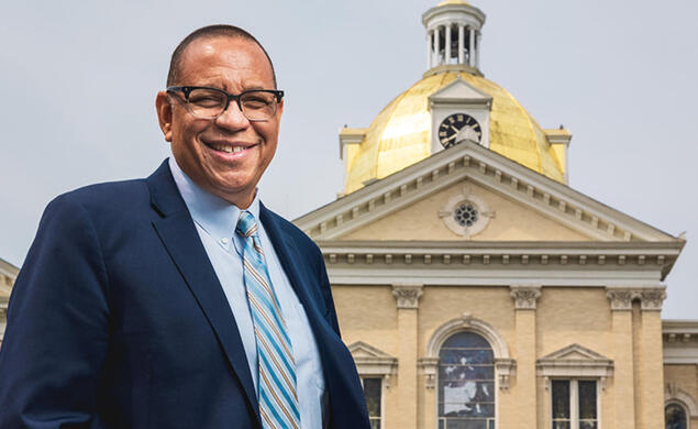 Dale Caldwell ’82 in front of a building with a gold dome at Centenary University.
