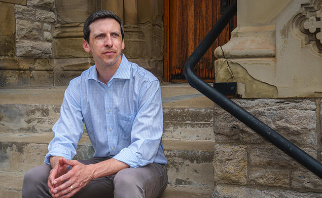P.G. Sittenfeld ’07 sits on stone steps.