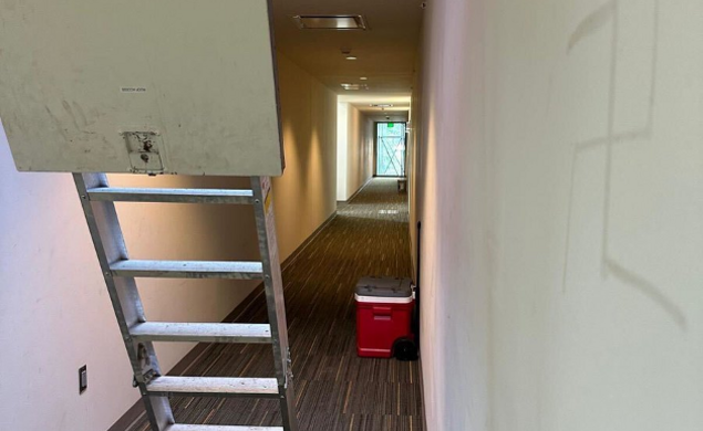 Remnants of graffiti on the wall of a hallway in the Lawrence Apartments