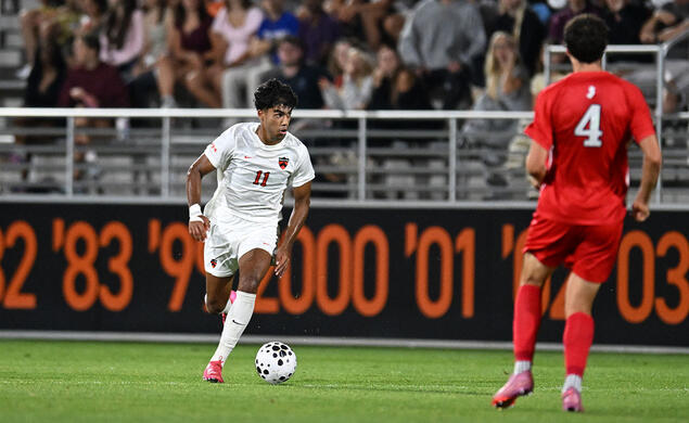 Danny Ittycheria, left, dribbles the ball against a Rutgers defender