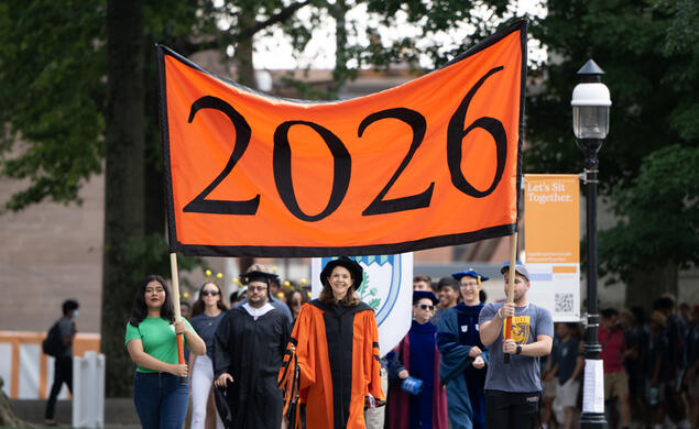 Students from the Class of 2026 march with a class year banner during the prerade