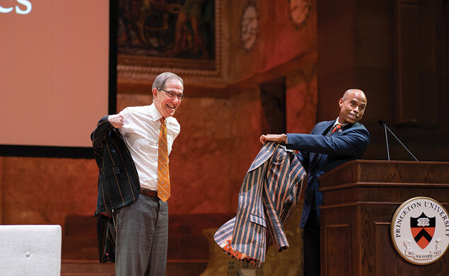 APGA President Laurence Latimer *01 surprises me onstage during the Many Minds, Many Stripes conference with a new APGA Reunions jacket. 