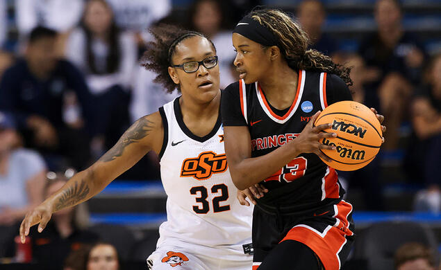 NCAA_MadisonStRose.jpg A woman blocks another holding a basketball during a game.