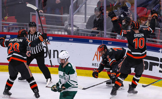 P84_0498_ECAC.jpg Hockey players celebrate a goal with arms raised