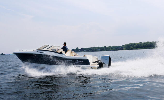 a boat using a Flux Marine motor speeding through the water