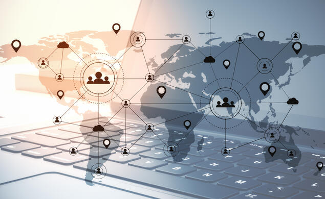 Graphic of a world map with various pins and digital media over a laptop to represent remote work