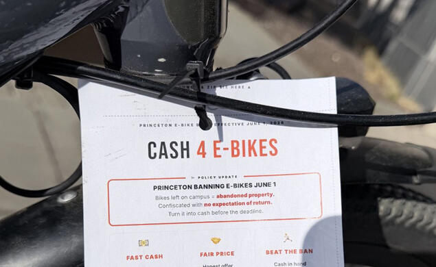 Cash 4 E-Bikes flyer on the handlebar of a parked e-bike 