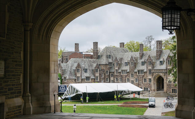Crews setting up a tent on campus