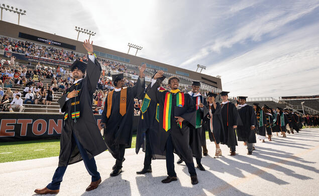OTC_Commencement walking.jpg students walk into the Commencement ceremony