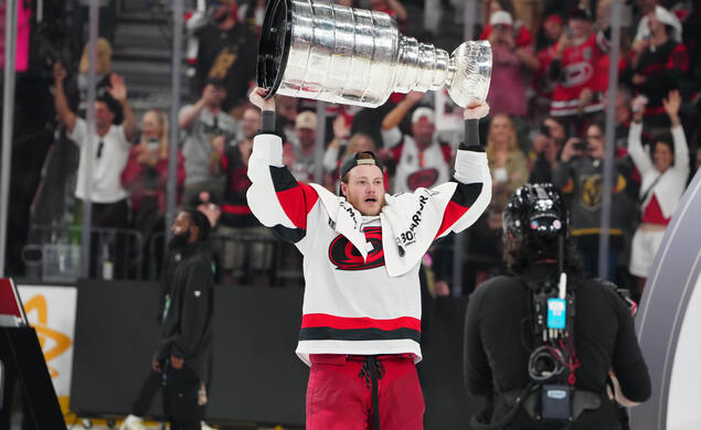 Eric Robinson ’18 raises the Stanley Cup after the Carolina Hurricanes beat the Vegas Golden Knights in six games.
