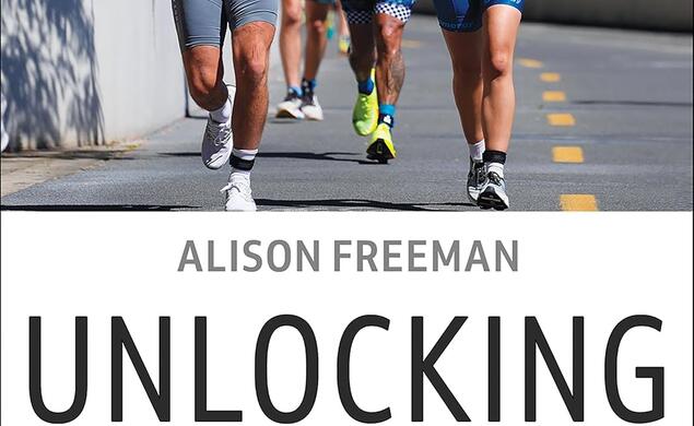 Photo of four people running down the a paved road on top with the book's title below