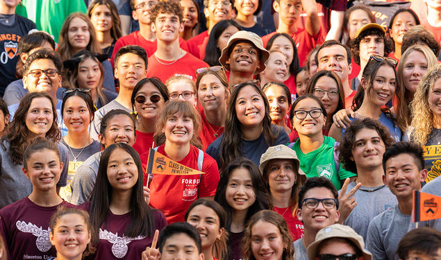 Group of students in colorful residential college t-shirts