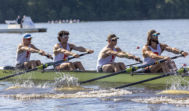 Four rowers from an eight man boat in action at a rowing regatta