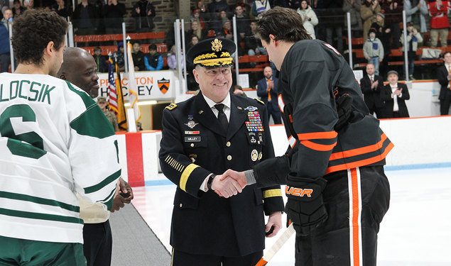 On the ice, Gen. Mark Milley ’80, chair of the Joint Chiefs of Staff, shakes hands with Princeton captain Pito Walton ’23 after the ceremonial puck drop.