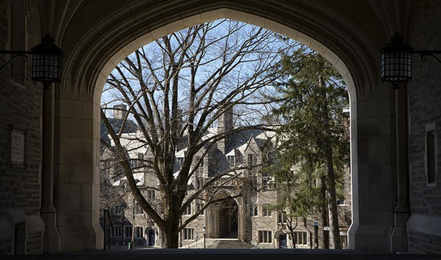 This is a photo of a gothic campus building viewed through an archway.