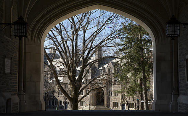 This is a photo of a gothic campus building viewed through an archway.