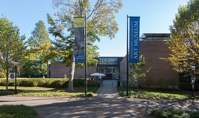 Two flags — one reading Princeton University Art Museum — flank the museum's old entrance.