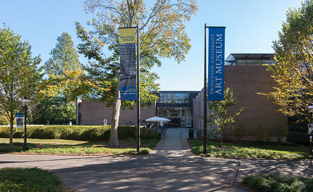 Two flags — one reading Princeton University Art Museum — flank the museum's old entrance.