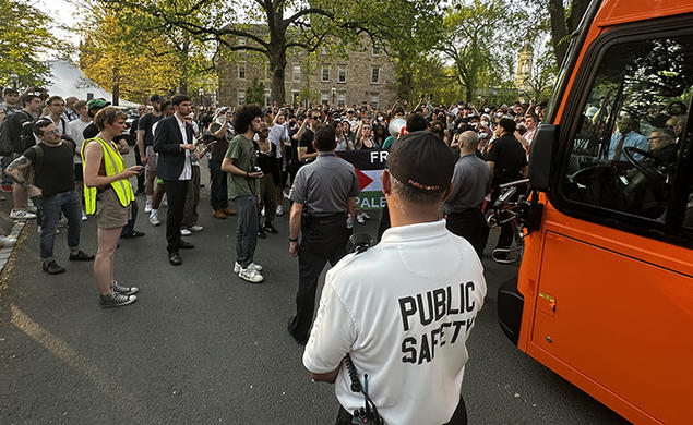 Protesters around the bus in front of Clio Hall.