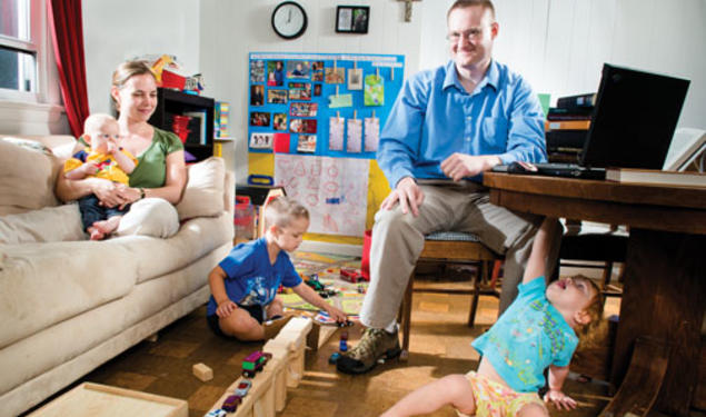 Dan Johnson GS; his wife, Julie; and their children Anders (5), Lucia (2), and Henrik (5 months) make good use of their small living room.