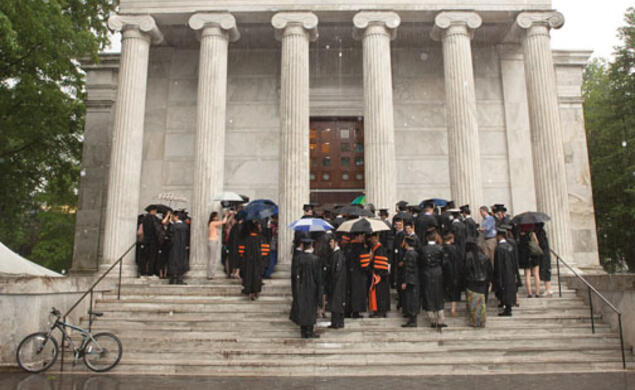 A thunderstorm sent graduate students to Whig Hall to receive their hoods in a short ceremony. The next day, graduate school dean William B. Russel hooded ­students under sunny skies.