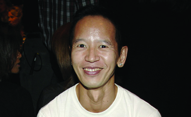 Long Nguyen ’84 wearing a white T-shirt that says PRINCETON in orange letters.