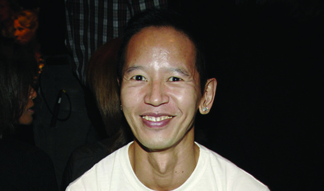 Long Nguyen ’84 wearing a white T-shirt that says PRINCETON in orange letters.