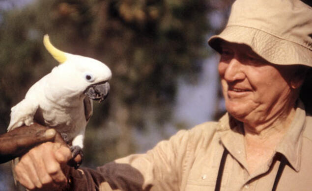 Train meets a white parrot in August 1994, when he was with the World Wildlife Fund.