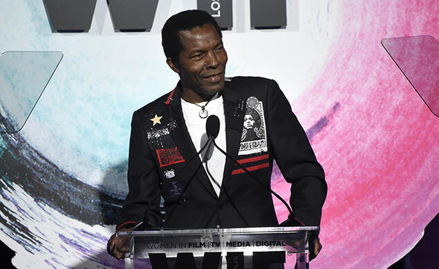 Actor Isaach De Bankolé speaks at a podium.