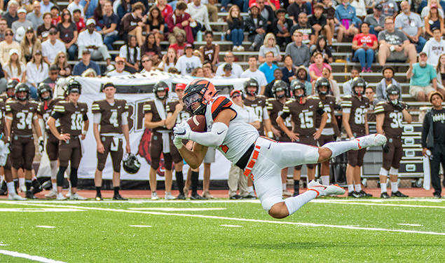 Wide receiver Dylan Classi ’23 dives sideways to catch the ball.