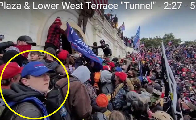 A yellow circle has been drawn about a boy in the foreground, wearing a blue baseball cap. In the background a crowd climbs over the wall around the Capitol.