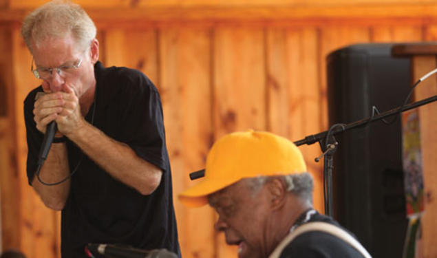 Adam Gussow ’79 *00, left, and his partner in music, Sterling Magee, known as Satan, perform at the Hill Country Harmonica festival in May.