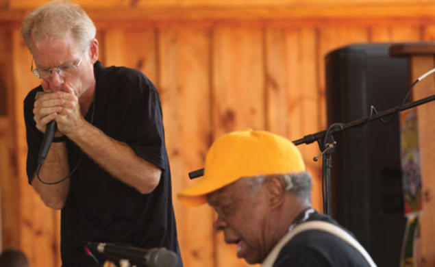 Adam Gussow ’79 *00, left, and his partner in music, Sterling Magee, known as Satan, perform at the Hill Country Harmonica festival in May.