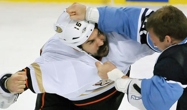 George Parros ’03, left, who plays right wing for the NHL’s Anaheim Ducks, brawls with a Florida Panthers player in February.