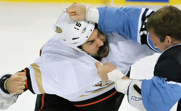 George Parros ’03, left, who plays right wing for the NHL’s Anaheim Ducks, brawls with a Florida Panthers player in February.