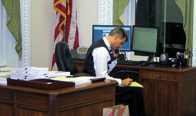 Dressed for a White House party, Alan Krueger works on statistics needed for a 2011 presidential speech.