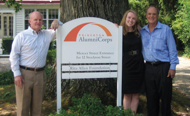  Standing next to the sign introducing Princeton AlumniCorps — formerly Princeton Project 55 — are, from left, president Bill Leahy ’66, executive director Kathleen Reilly, and board chairman Kenly Webster ’55.