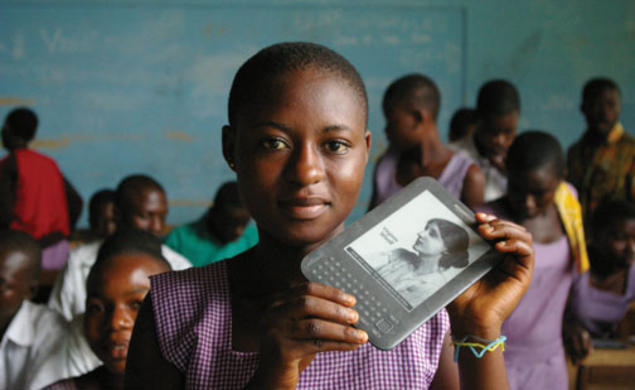 A girl in Ghana holds an e-reader provided by Worldreader.org.