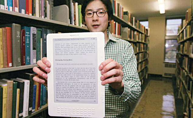 Brian No ’10 with the Kindle DX e-reader, which is being used by three Princeton classes in a pilot program this fall.