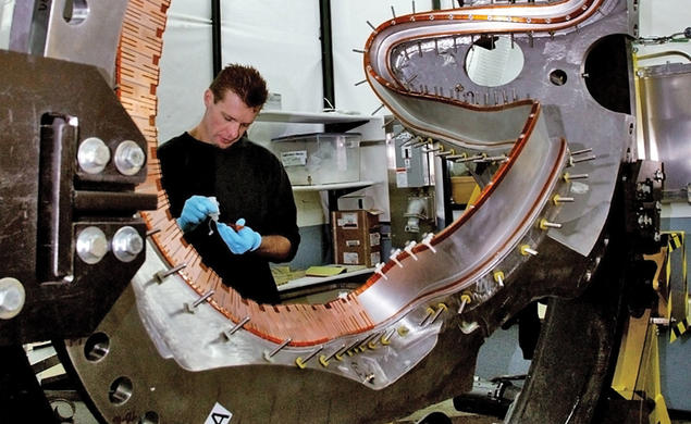 PPPL technician Doug Voorhees works on one of the stellerator’s 18 coils. The project is being shut down.