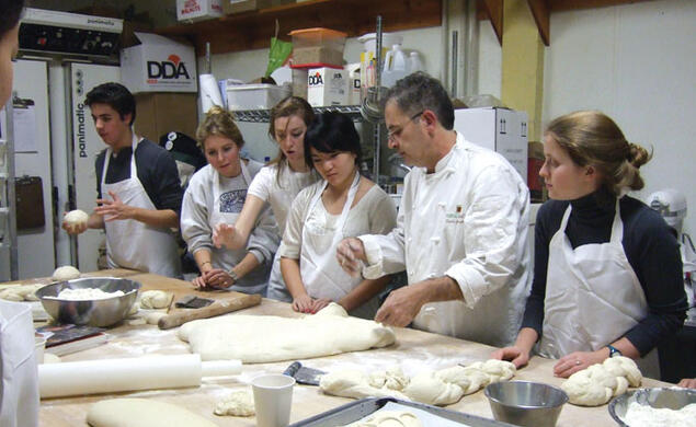 From left, Joseph Vellone ’10, Katy Andersen ’08, Arianna Gianola ’09, Yuanbo Liu ’10, and Emily Forscher ’10 learn how to make baguettes and ciabatta with Witherspoon Bread Company master baker Denis Granarolo last year.