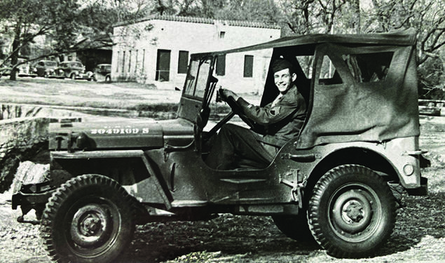 Ernest Stock ’49 driving a Jeep