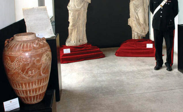 Art objects returned to Italy by American institutions in December were put on display in Rome; the red jar at left appears identical to one given by former antiquities dealer Edoardo Almagià ’73 to the Princeton art museum in 1999.
