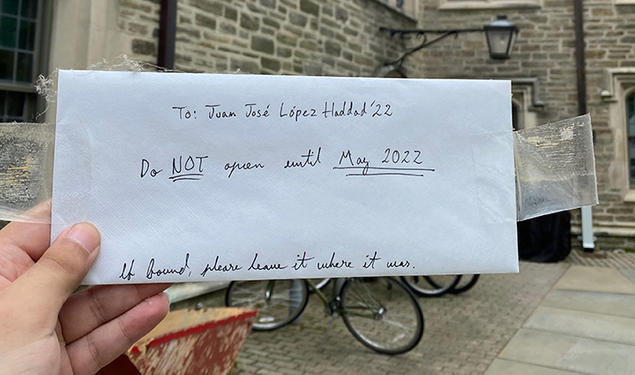 A hand holds the envelope Haddad left in his freshman room; it reads: To: Juan Jose López Haddad ’22, Do NOT open until May 2022. If found, please leave it where it was.