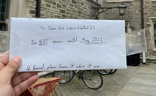 A hand holds the envelope Haddad left in his freshman room; it reads: To: Juan Jose López Haddad ’22, Do NOT open until May 2022. If found, please leave it where it was.