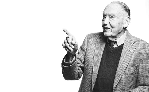 A black and white Image of John Bogle class of 51 pointing. 