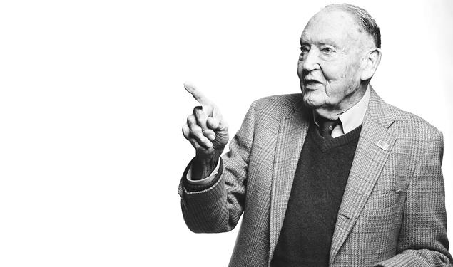 A black and white Image of John Bogle class of 51 pointing. 