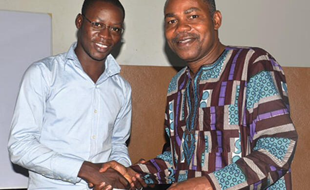 Leonard Wantchekon, right, congratulates Romaric Samson on earning a master’s degree from the institute in Benin, West Africa, that Wantchekon founded.