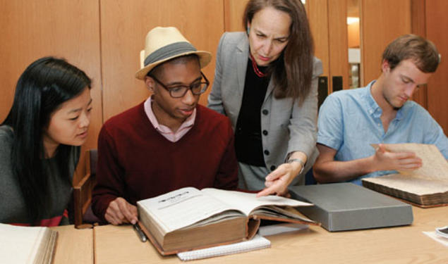 Reviewing 18th- and 19th-century faculty minutes in Mudd Library are, from left, Janie Lee ’15, Micheal Gunter ’14, Professor Martha Sandweiss, and Thatcher Foster ’14.